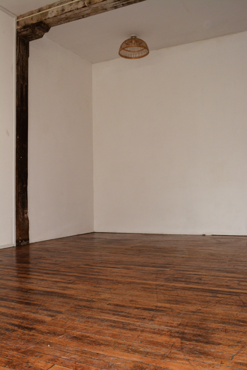 Photograph showing the 12 foot 4 inch ceilings and hardwood floors of loft 2R at the Warehouse