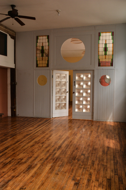 The center space in the loft showing stain glass and oversized double doors